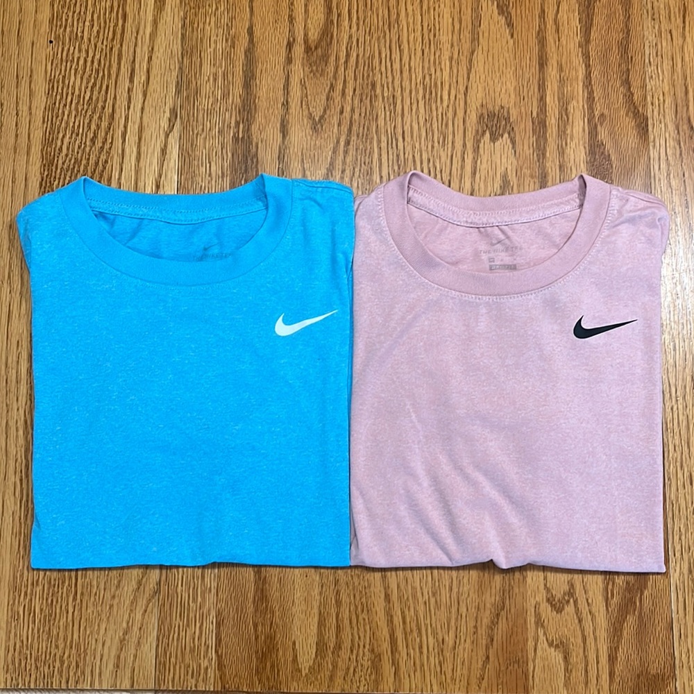 Two women’s medium Nike tees